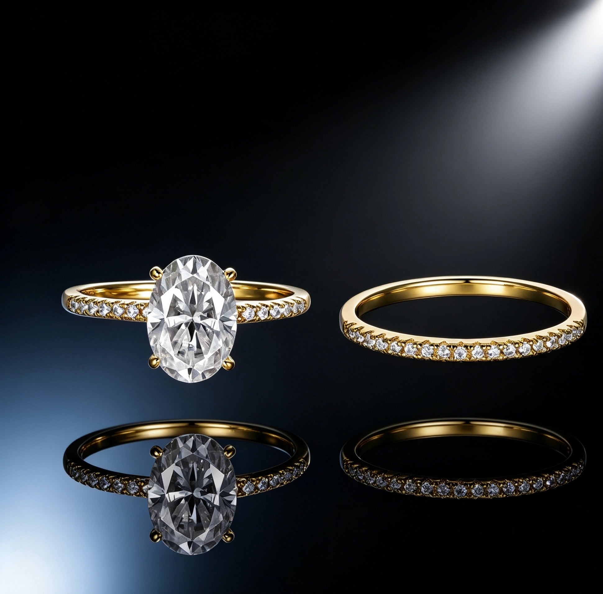 Oval moissanite solitaire engagement ring and matching pavé band in gold-plated S925 silver on a reflective surface.