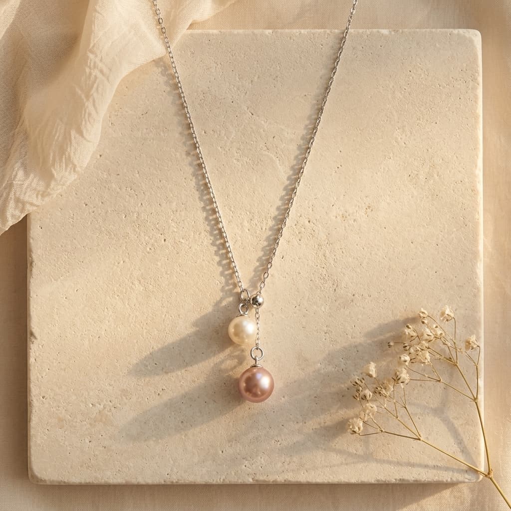 Double pearl pendant necklace with a 6-7mm peach pink and 4-5mm white freshwater pearl on a 925 sterling silver chain.