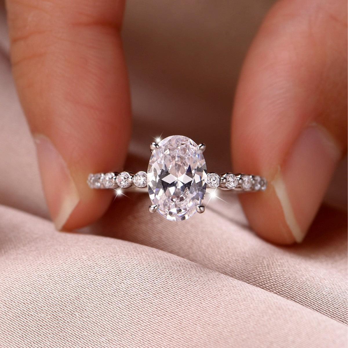 Oval moissanite engagement ring in S925 silver with a full eternity band of alternating marquise and round stones.