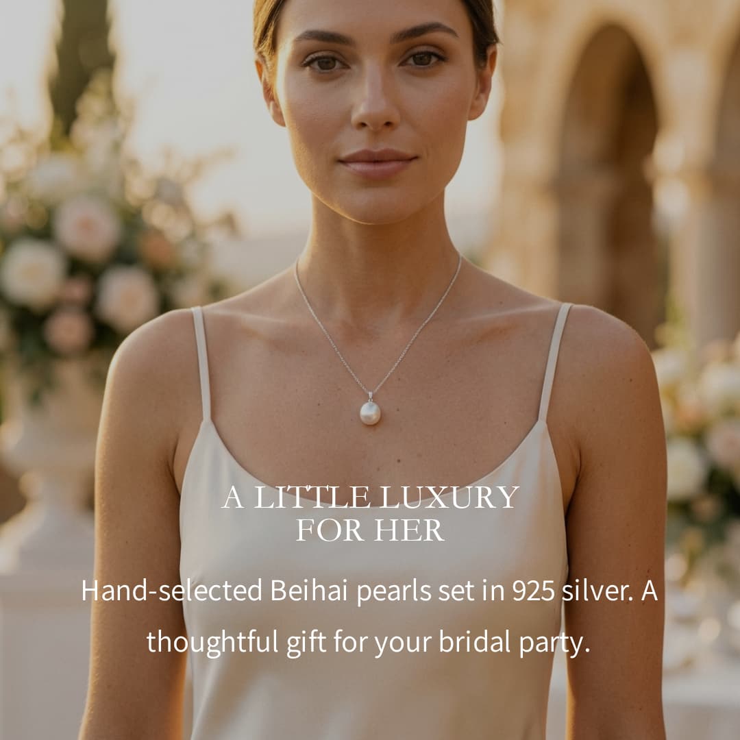Double freshwater pearl pendant necklace with 6-7mm peach and 4-5mm white pearls on a 925 sterling silver chain.