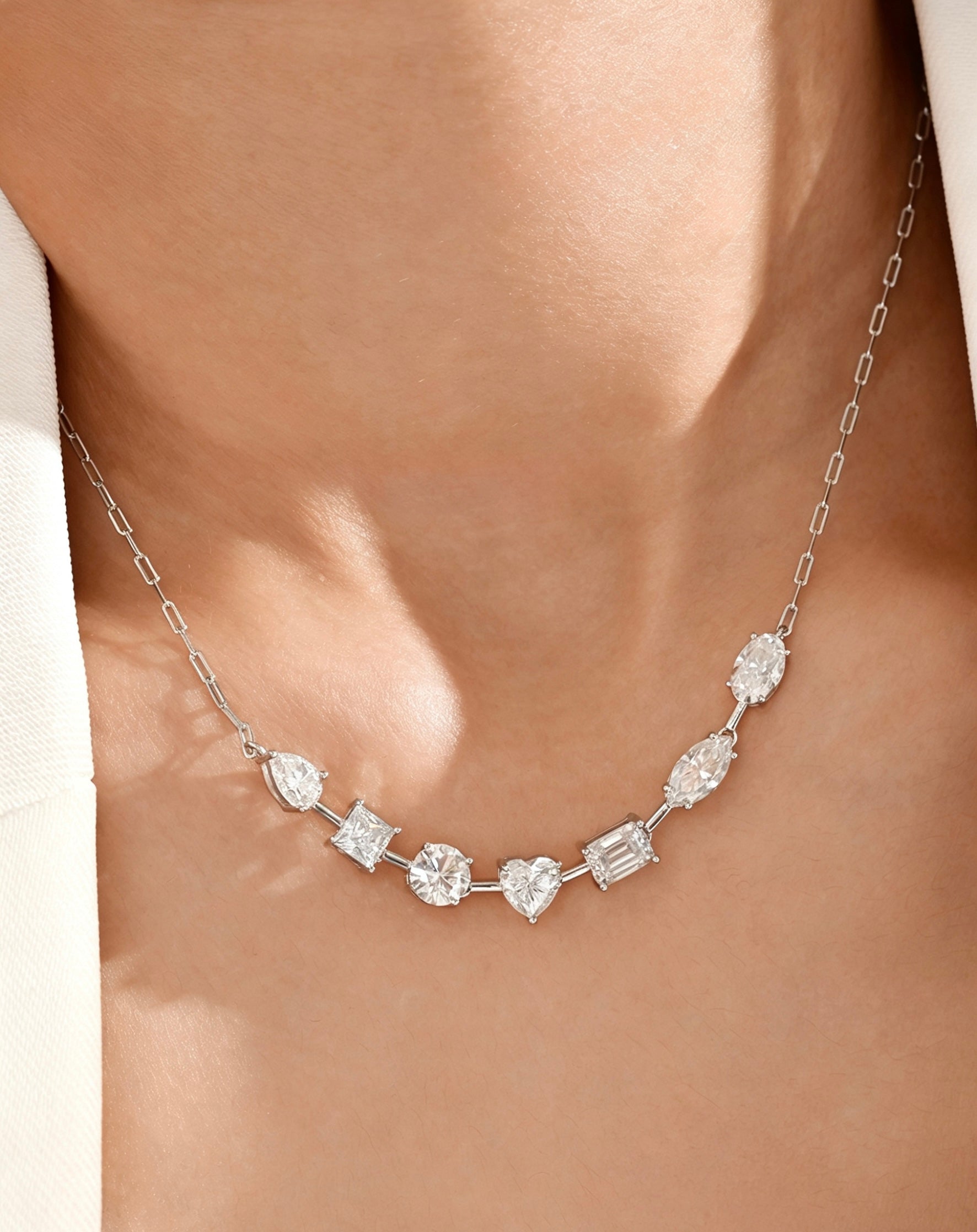 Luvymia sterling silver necklace featuring multi-shape D-color moissanite stones on a delicate chain.