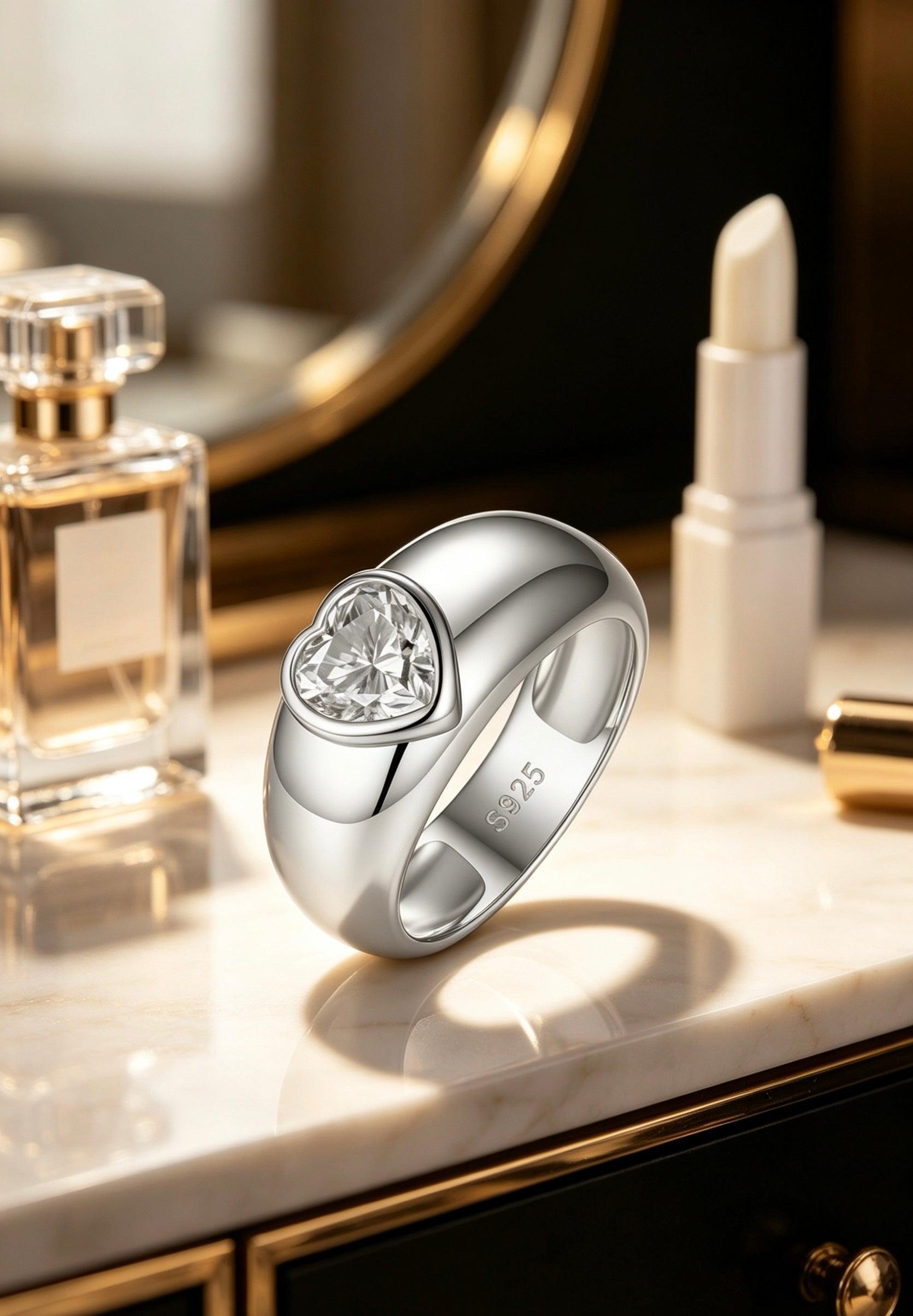 1.2ct heart-cut moissanite ring in a polished S925 silver dome band with a modern bezel setting.