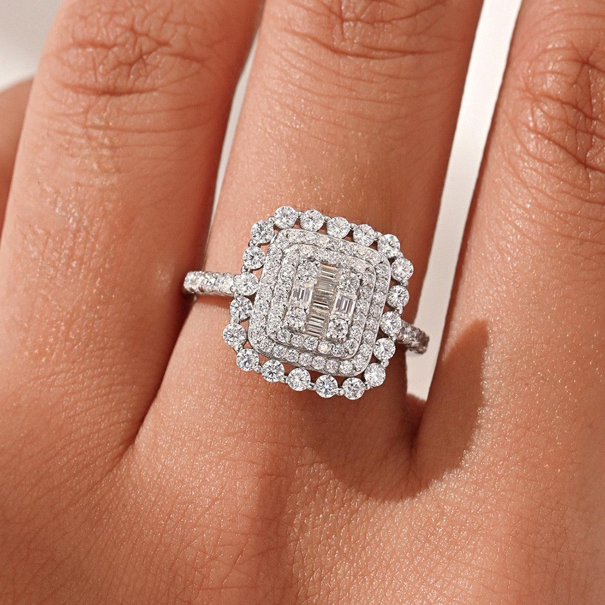 Square double halo moissanite ring in S925 silver featuring a baguette cluster center and pavé band on a finger.