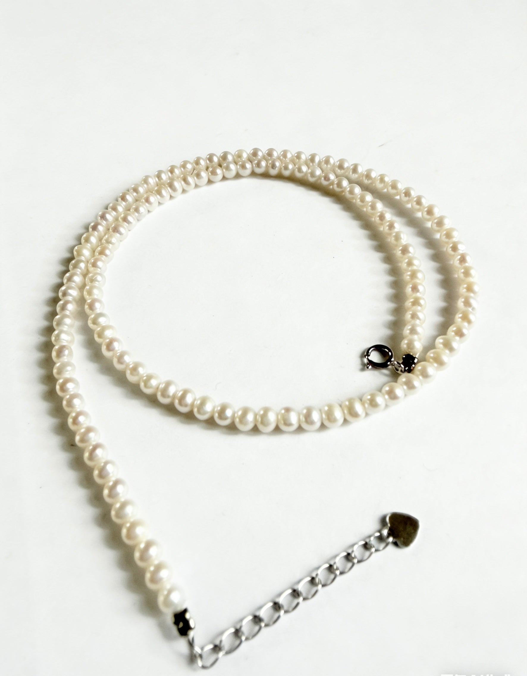 Minimalist 3–4mm white freshwater pearl choker necklace with a 925 sterling silver clasp and adjustable extender chain.