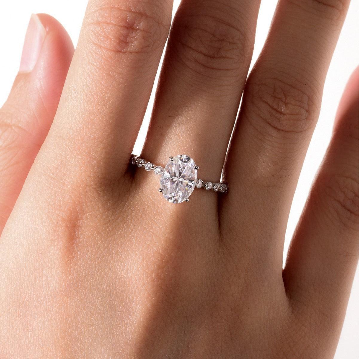Oval moissanite engagement ring in S925 silver with a full eternity band of alternating marquise and round accent stones.