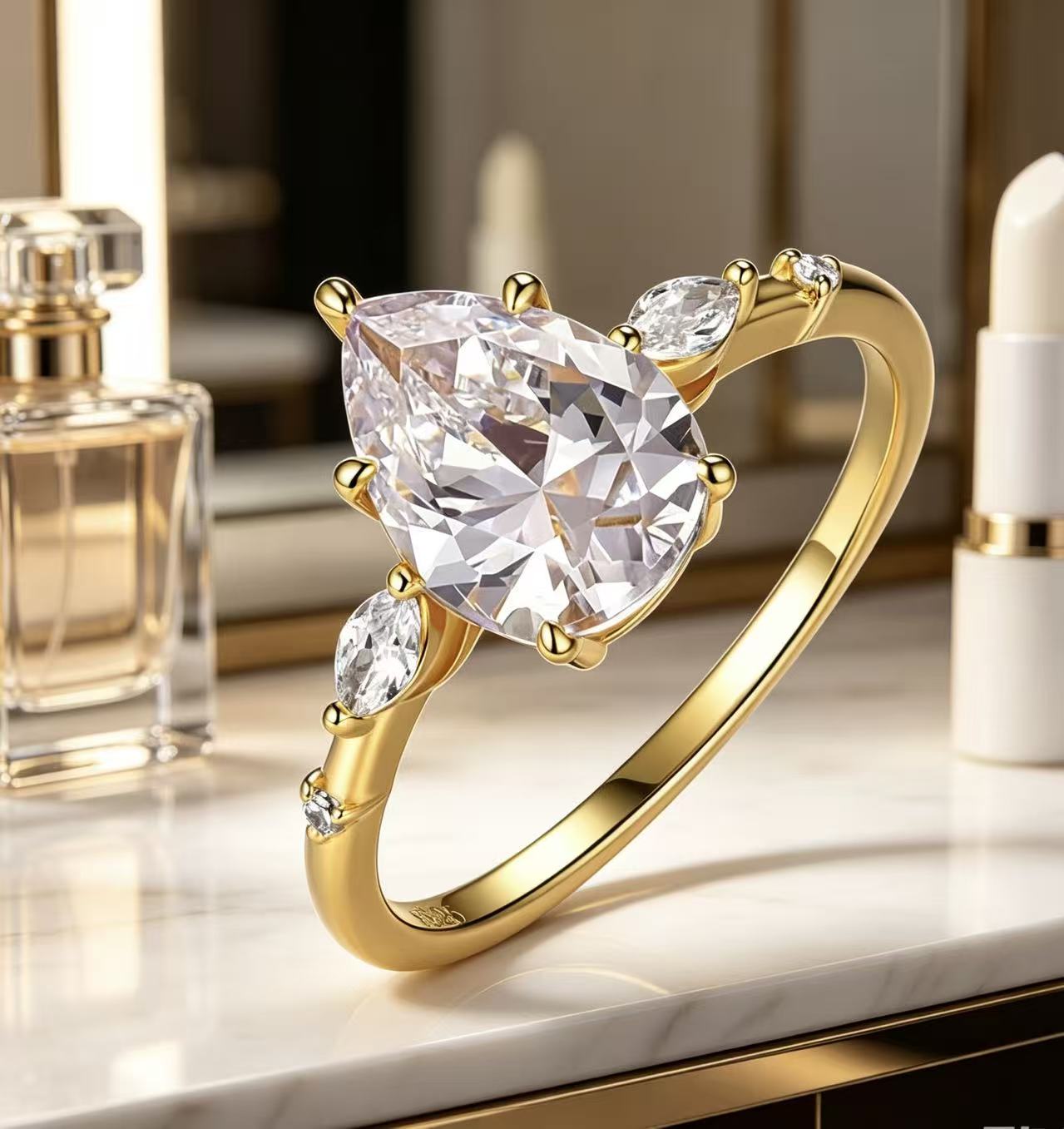 Gold pear-cut moissanite engagement ring with scattered marquise and round petal accents on a slim band.