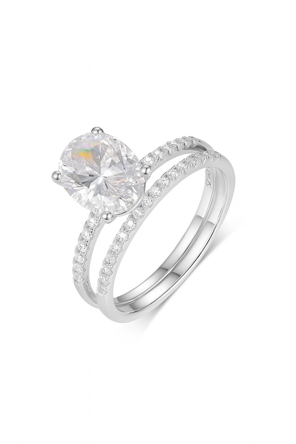 Oval moissanite solitaire engagement ring and matching pavé band in S925 silver with a four-prong setting.