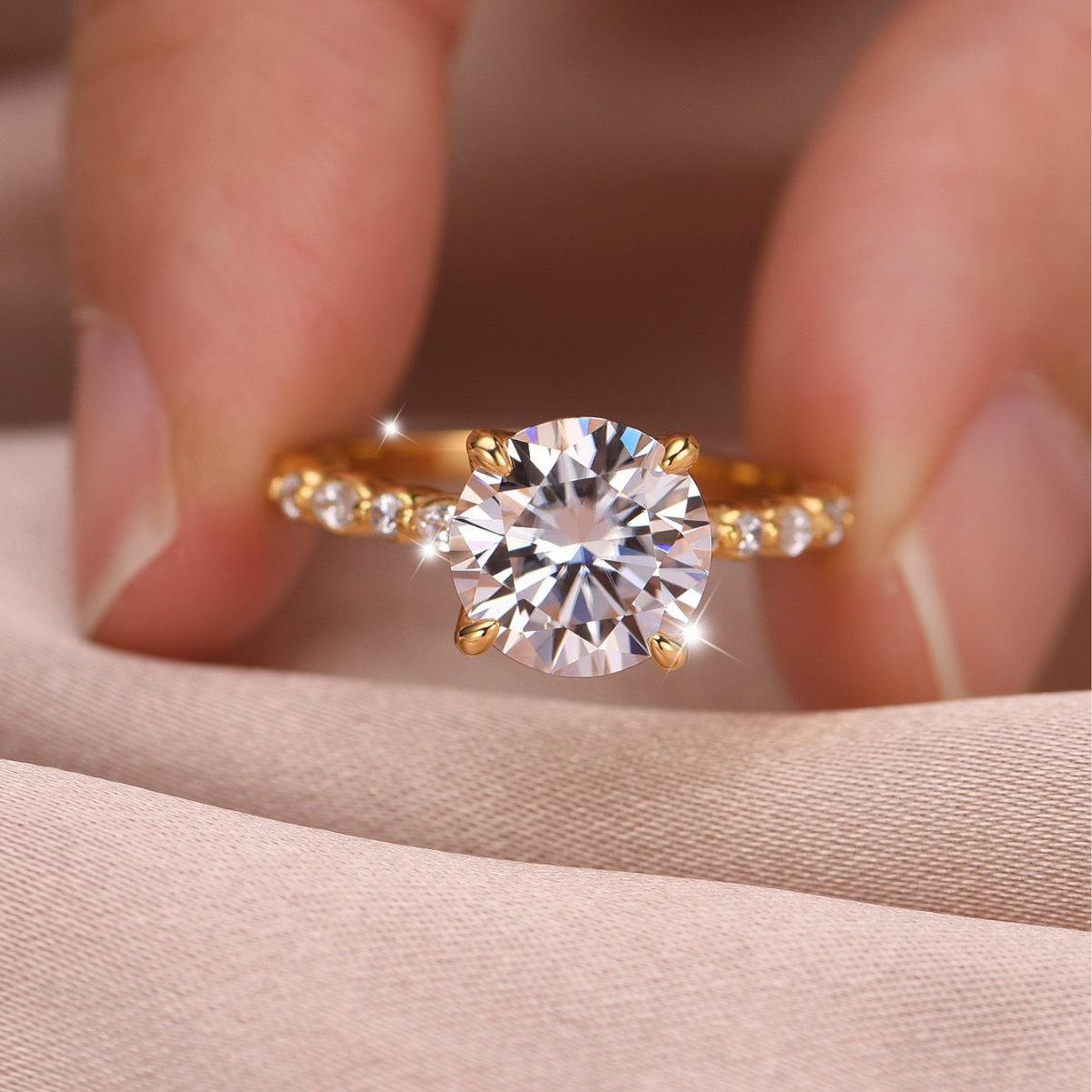 9mm round moissanite ring in gold-plated S925 silver with marquise-cut accent stones on the band.