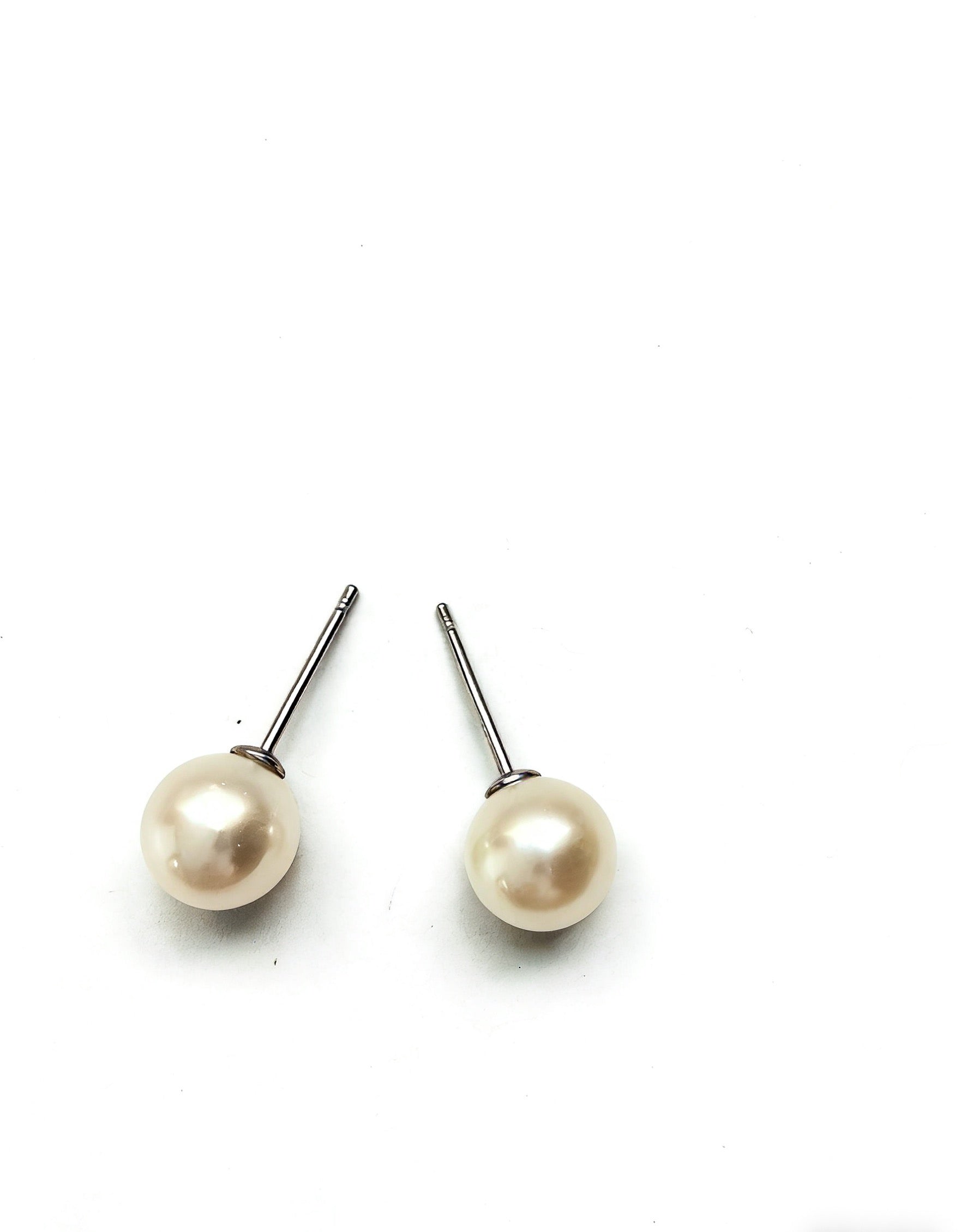 7mm white freshwater pearl stud earrings with polished 925 sterling silver posts on a clean white background.