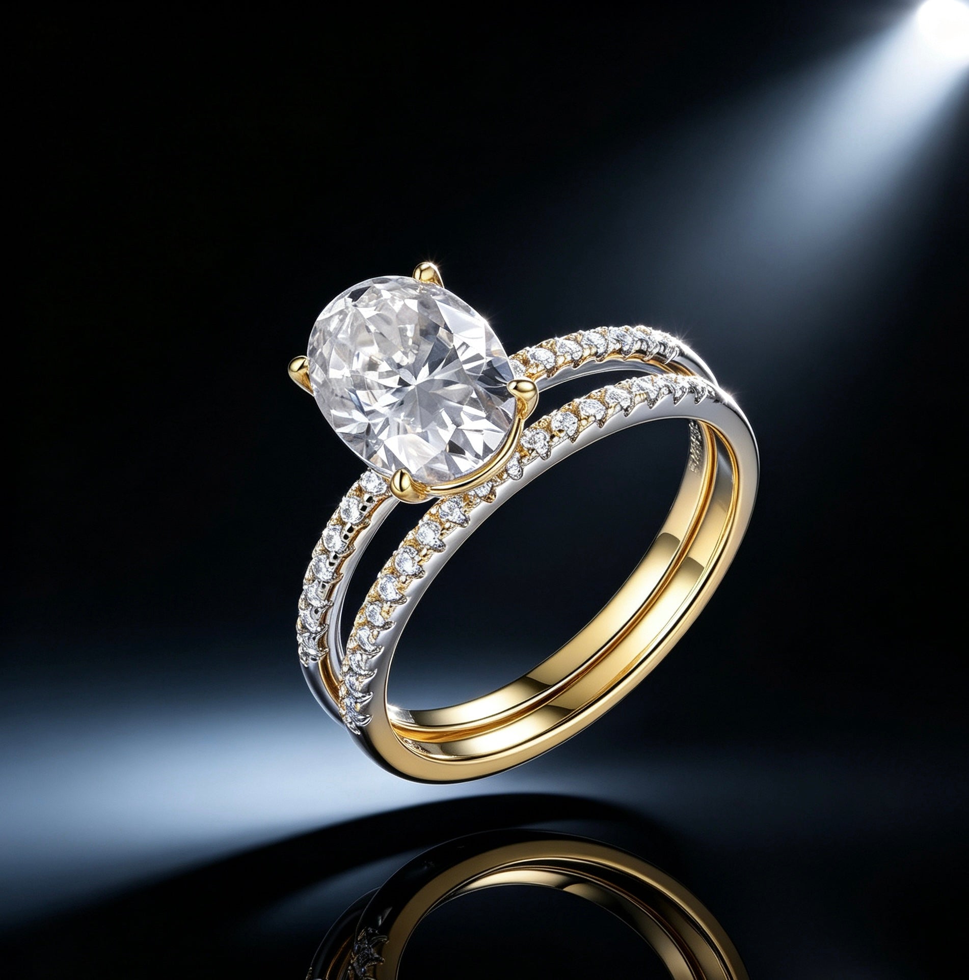 Oval moissanite solitaire engagement ring set with a matching pavé band in two-tone gold and silver on a black background.