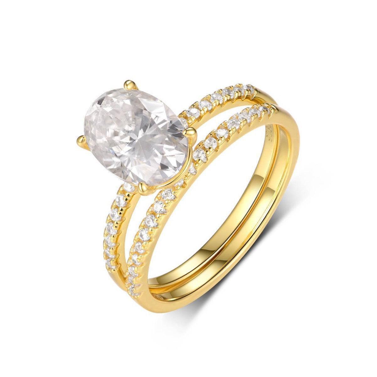 Gold oval moissanite solitaire engagement ring set with a pavé band in S925 silver.