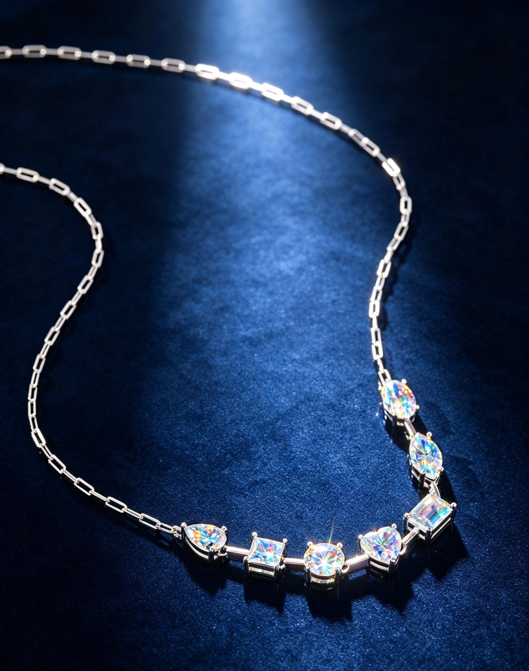 Luvymia sterling silver necklace featuring multi-shape D-color moissanite stones on a dark blue velvet background.
