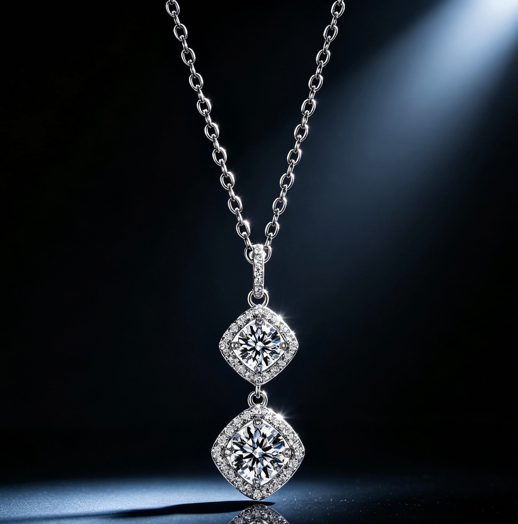 Luvymia double moissanite pendant necklace with two sparkling square-cut stones on a silver chain against a dark background.