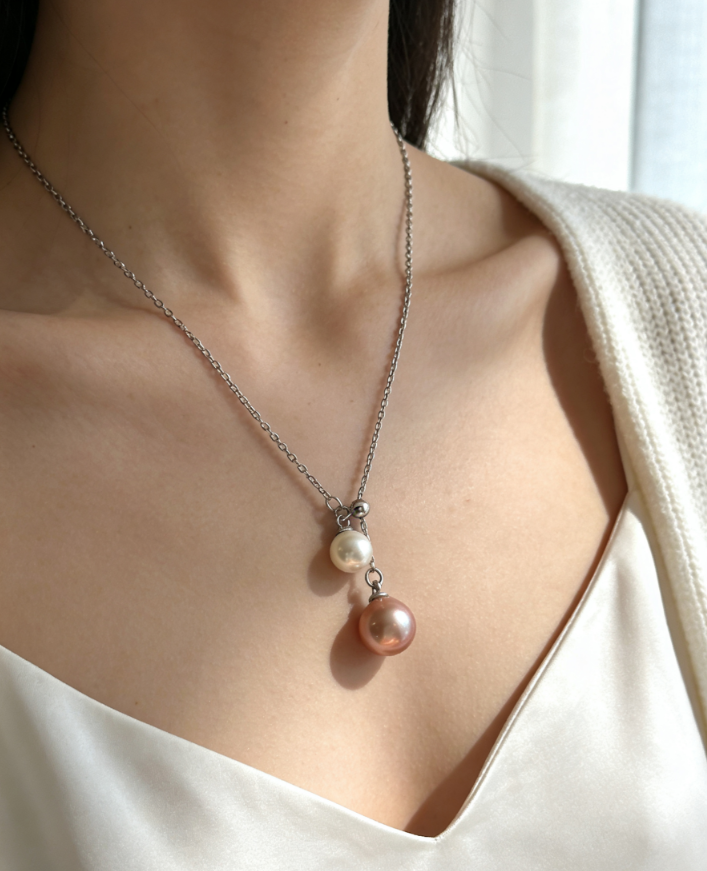 Double pearl pendant necklace with 6-7mm peach pink and 4-5mm white freshwater pearls on a 925 sterling silver chain.