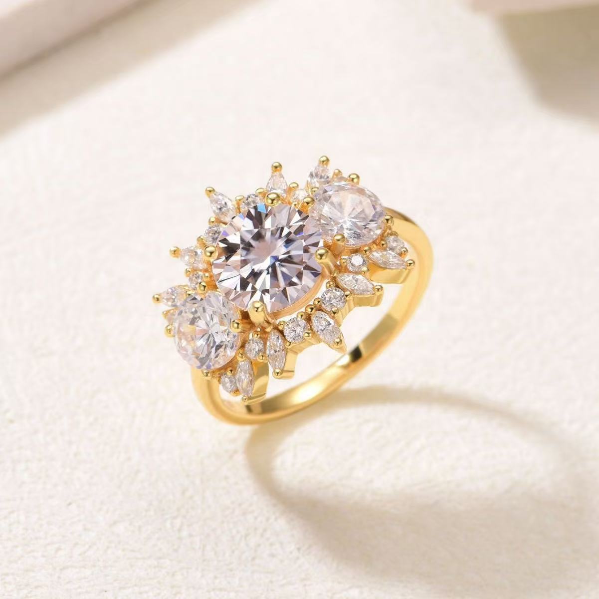 Gold floral engagement ring with an 8mm round moissanite center surrounded by marquise-cut petal accents.