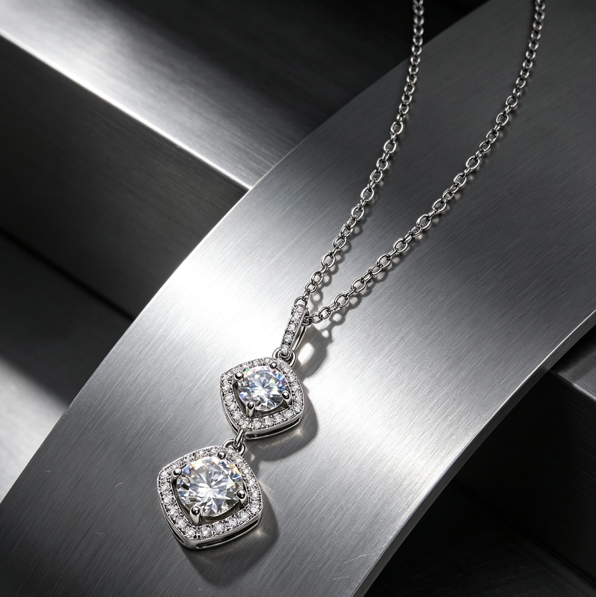 Luvymia double moissanite necklace with two round D-color VVS1 stones in a silver-toned halo setting on a metal display.