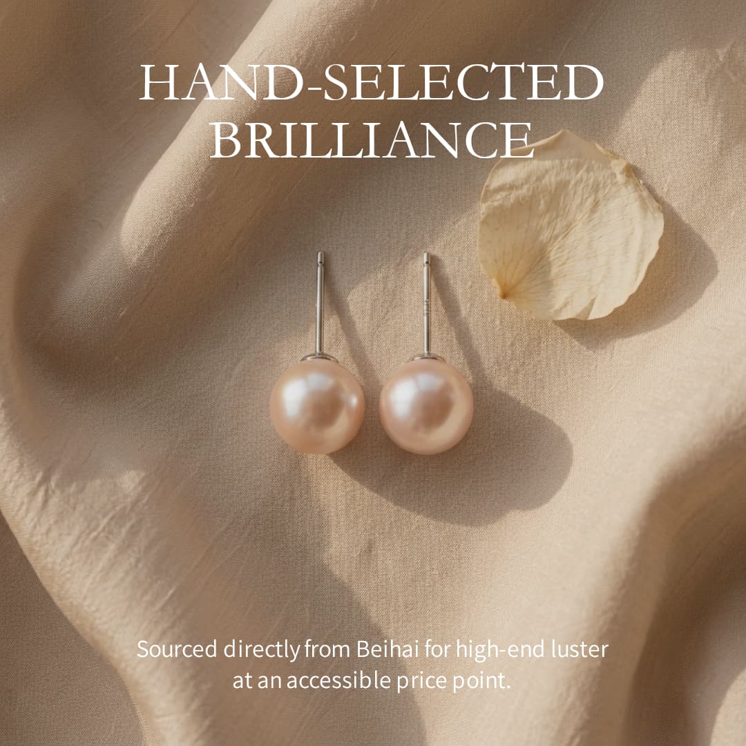 7mm round saltwater pearl stud earrings with sterling silver posts on a soft beige fabric background.