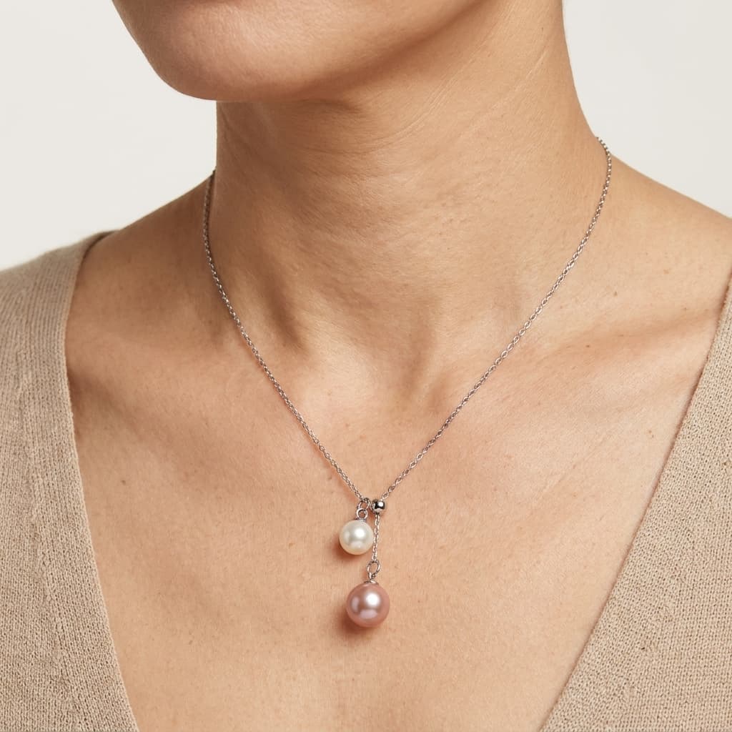 Double pearl pendant necklace with 6-7mm peach pink and 4-5mm white freshwater pearls on a 925 sterling silver chain.