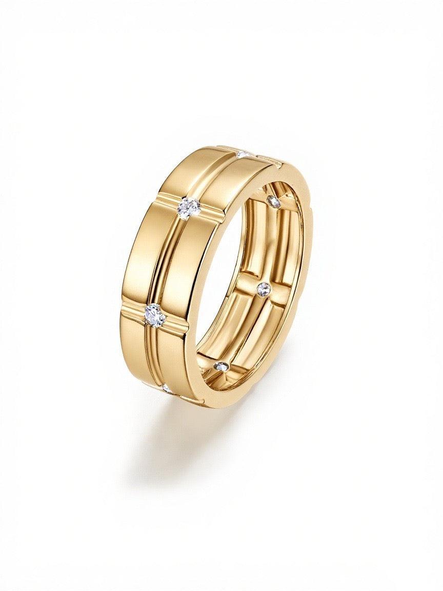 Wide gold-tone men's wedding band with a geometric grid pattern and seven flush-set moissanite stones.