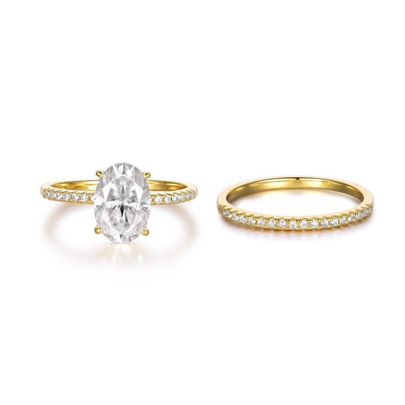 Oval moissanite solitaire engagement ring and matching pavé band in gold-plated sterling silver.