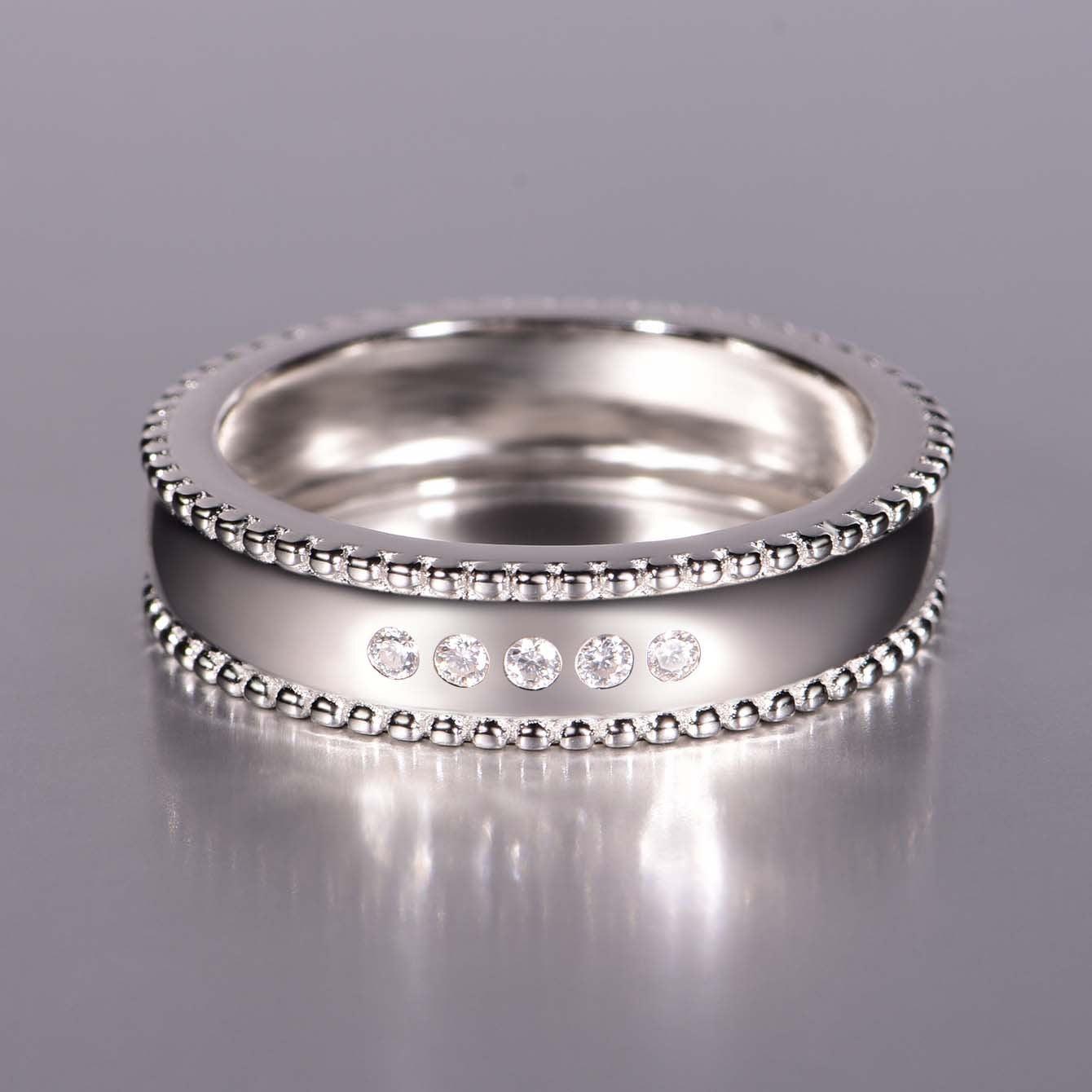 Wide sterling silver men's wedding band with beaded edges and five sparkling D-color moissanite stones.