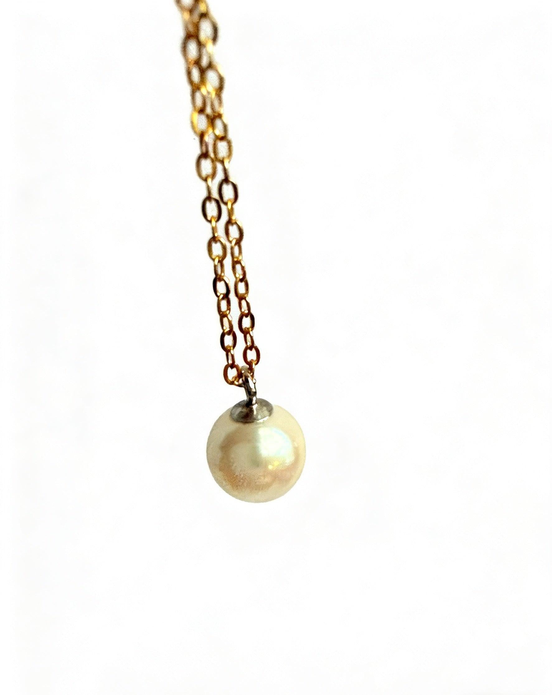 7mm round Hepu saltwater pearl pendant on a delicate gold-plated chain against a white background.