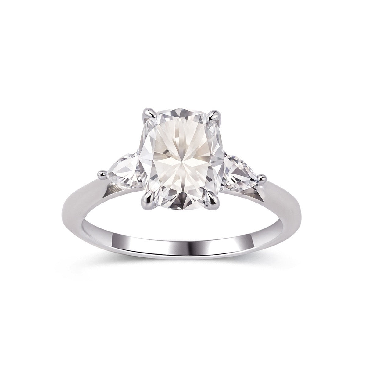 7x9mm cushion cut moissanite three-stone ring with pear side stones set in polished sterling silver.