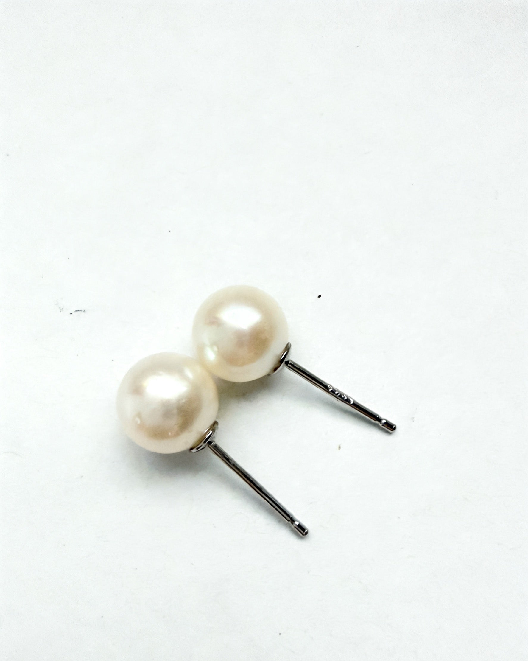 7mm white freshwater pearl stud earrings with 925 sterling silver posts on a white background.